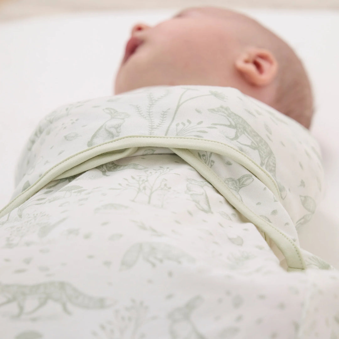 Close-up of ClevaMama ClevaSleep Forest Friends swaddle sleeping bag wrap on baby, newborn sleep sack detail