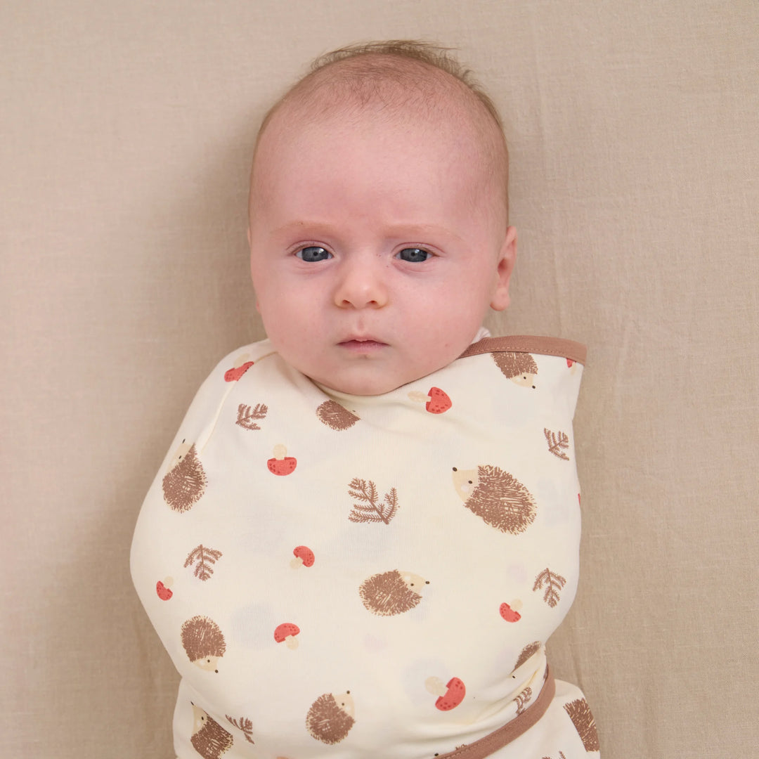 Close-up of baby swaddled in ClevaMama ClevaSleep hedgehog print swaddle sleeping bag, newborn sleep sack