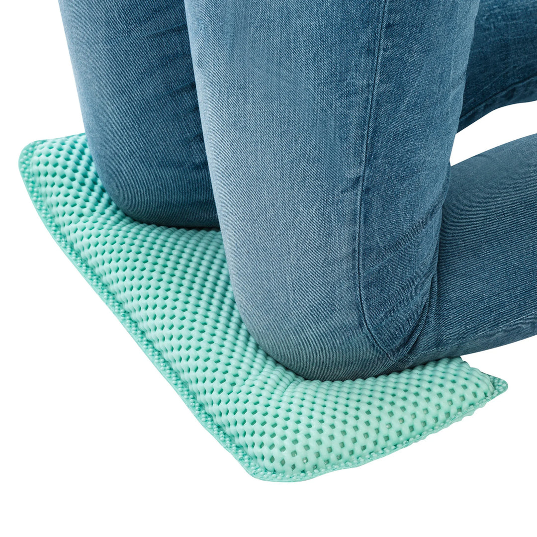 Close-up of knees resting on the ClevaMama kneeling cushion on a white background