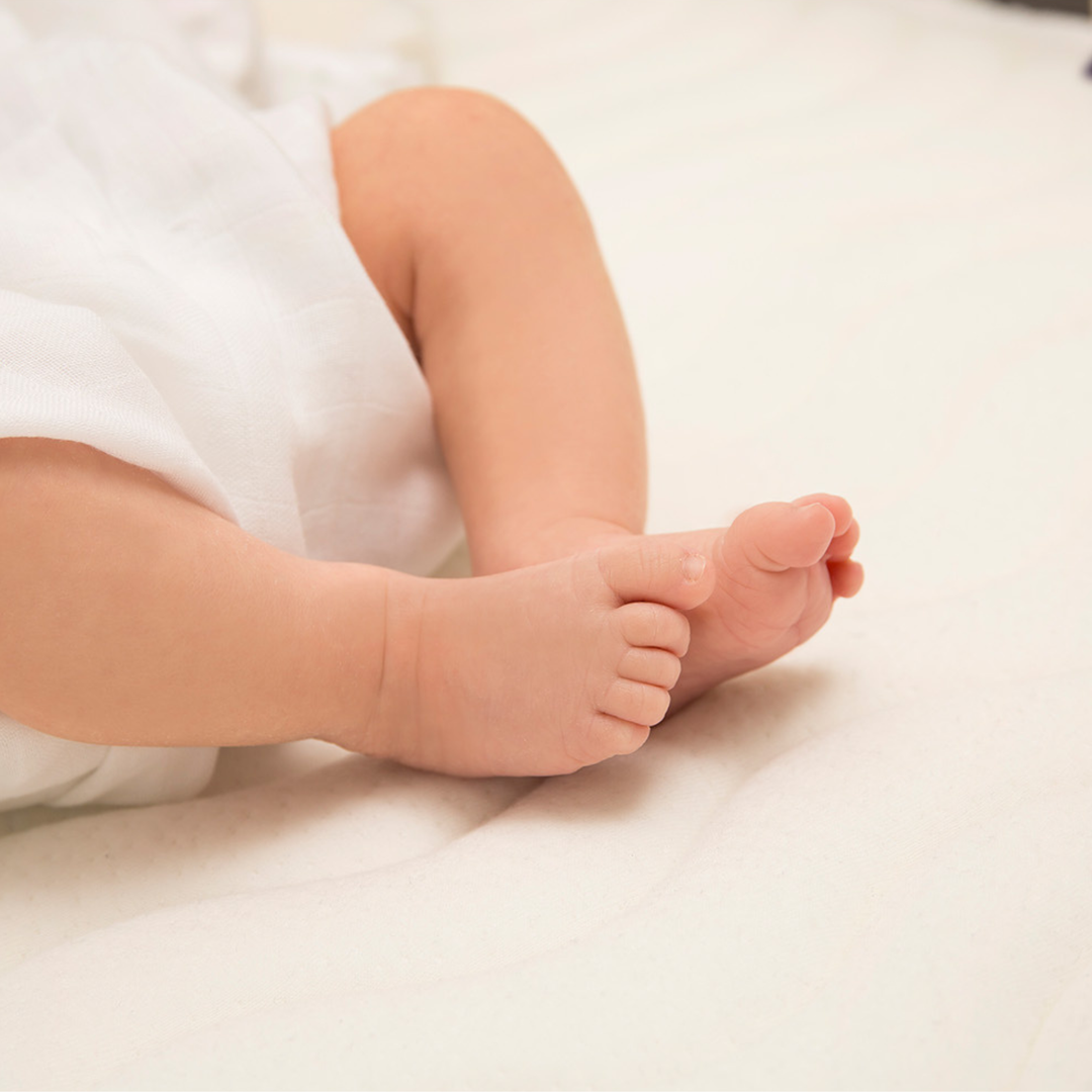 Close-up of baby feet resting on ClevaMama ClevaFoam Deluxe Pocket Sprung Mattress — soft, breathable, and supportive baby mattress designed for ultimate comfort, pressure relief, and safe sleep.