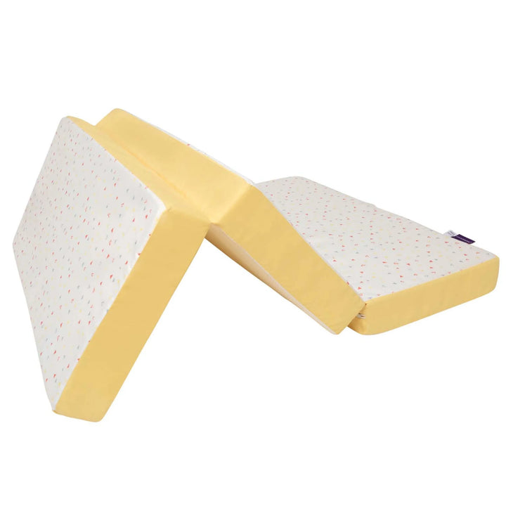 Yellow and white wedge-shaped ClevaFoam travel cot mattress on a white background
