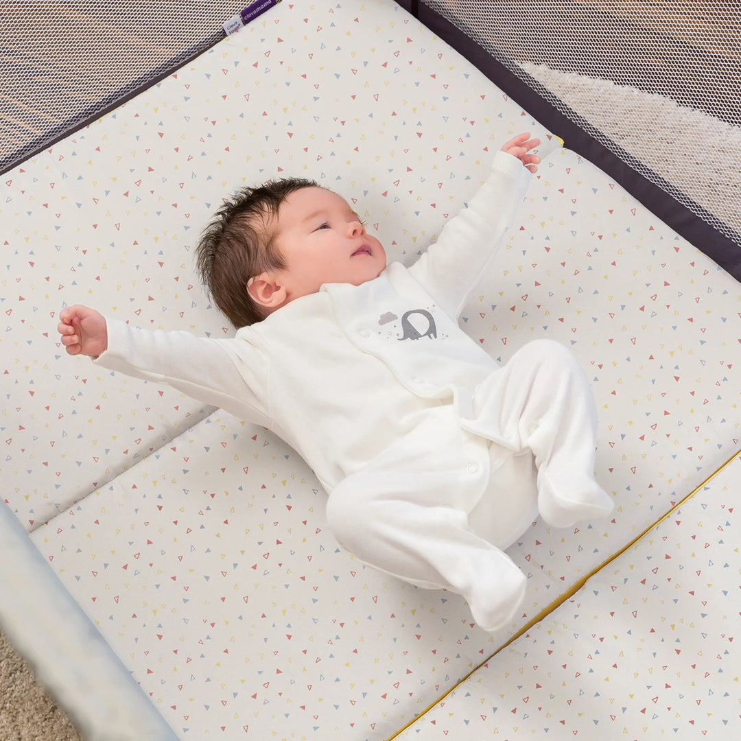Baby lying on a ClevaFoam travel cot mattress