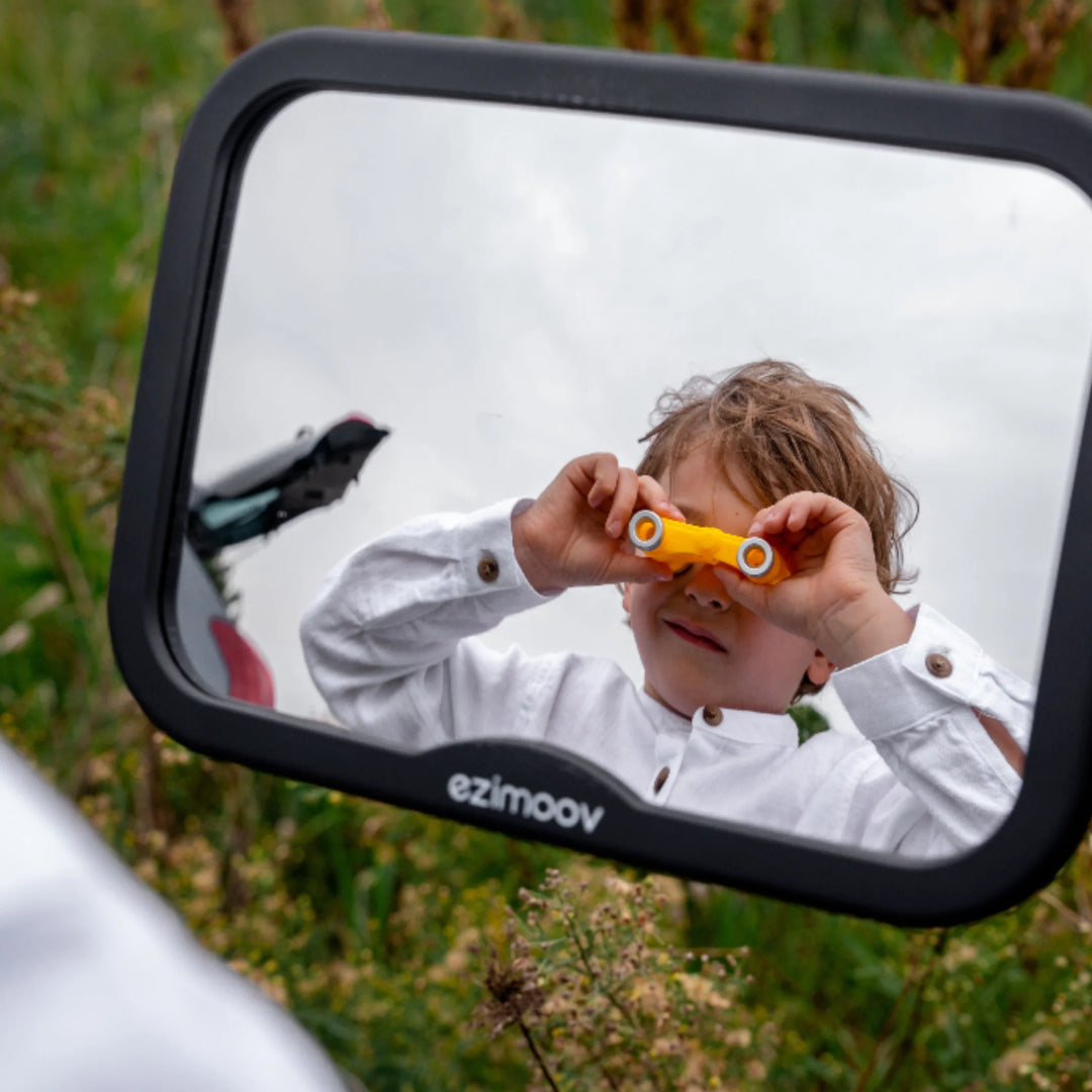 Ezimoov adjustable square back seat car mirror showing child outdoors holding toy binoculars