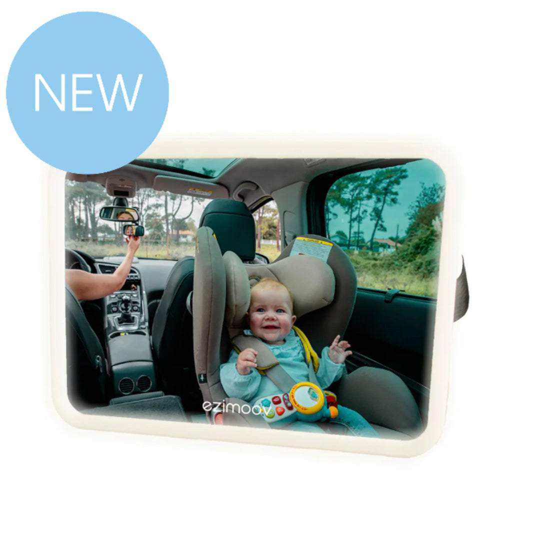 EziMoov LED Pro car seat mirror showing a happy rear-facing baby in a car seat, viewed clearly from the driver’s seat; wide, illuminated mirror design for safer visibility while driving.