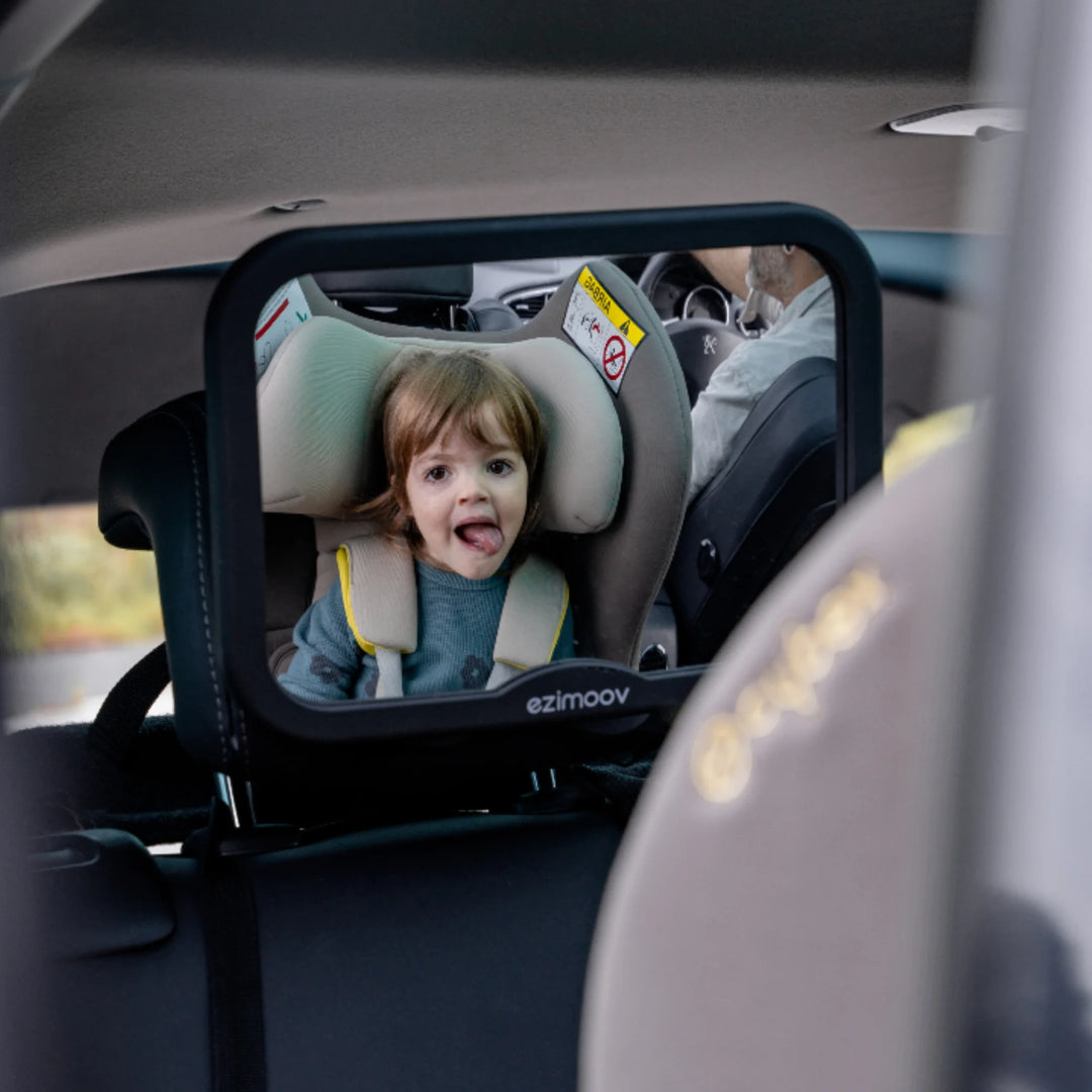 Rear-seat baby car mirror by Ezimoov showing a clear reflection of a happy toddler in a car seat, helping parents monitor their child safely while driving.