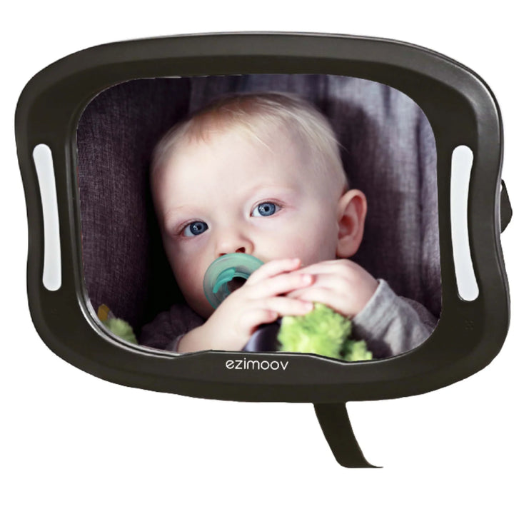 EziMoov LED baby car seat mirror showing a clear reflection of a rear-facing baby in a car seat, featuring integrated LED lights for improved visibility during day and night driving.
