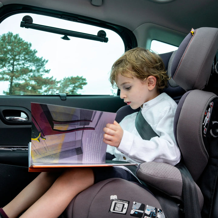 This image shows the Ezimoov Retractable Sun Shade installed on the window of a car.