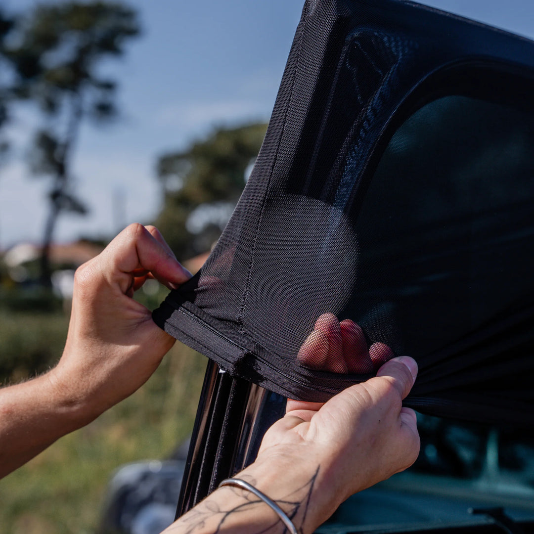 This image shows the stretchiness of the sun shade while being installed by the parent.