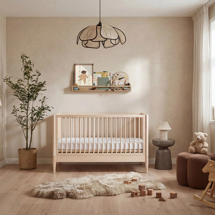 Natural wooden baby cot in neutral nursery room with soft decor, toys, and Scandinavian-style interior design