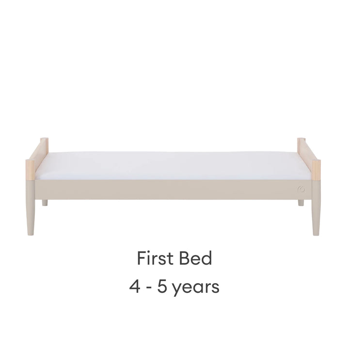 Gaia Baby Eos convertible cot in natural wood and cashmere finish configured as a first bed for 4–5 years on a white background.