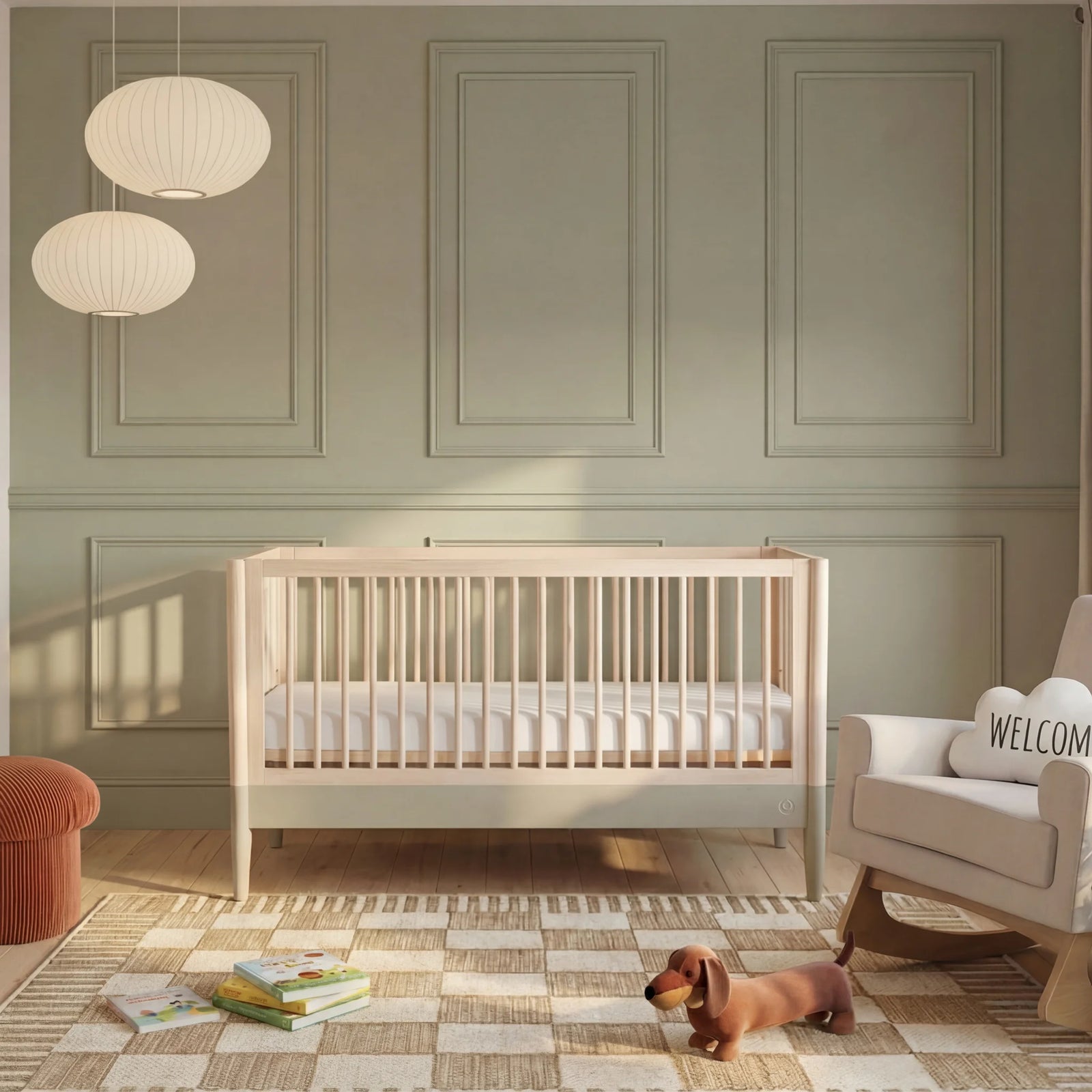 Gaia Baby Eos convertible wooden cot in natural desert sage finish in a modern nursery with books, rug and soft lighting