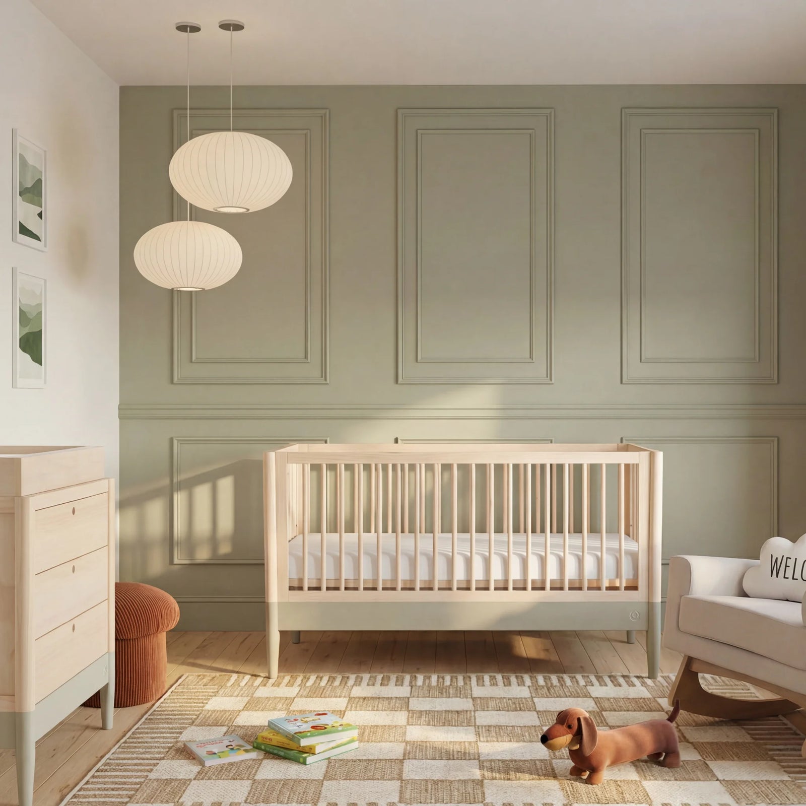 Gaia Baby Eos convertible cot in natural desert sage finish with matching dresser in a modern neutral nursery with soft lighting and wooden furniture.
