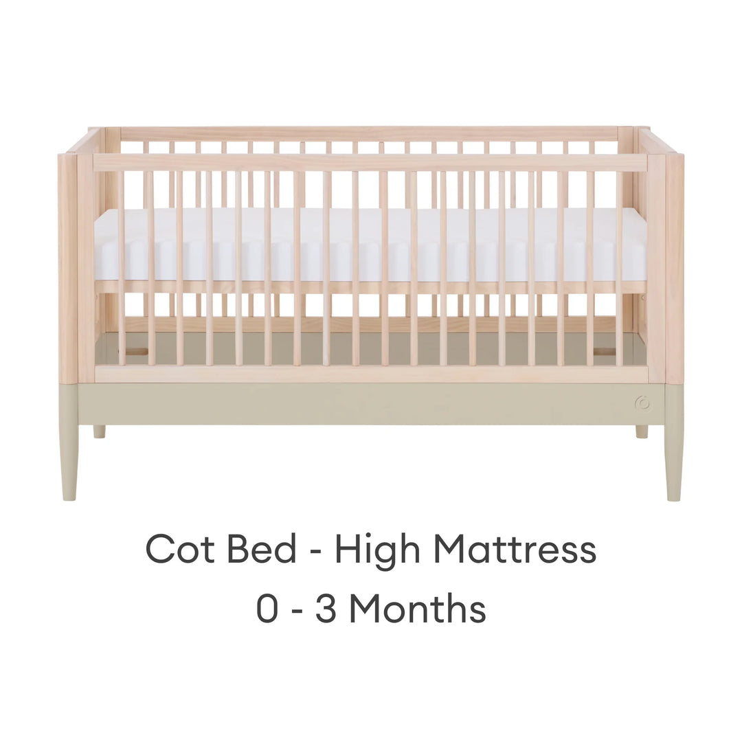 Gaia Baby Eos convertible cot in natural desert sage finish with mattress in high newborn position for 0–3 months on a white background.
