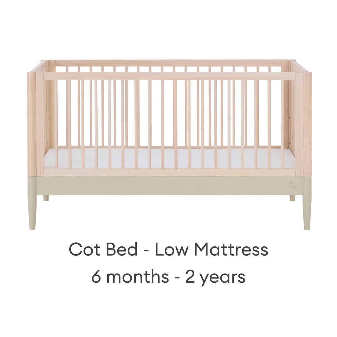 Gaia Baby Eos convertible cot in natural desert sage finish with mattress in low position for 6 months to 2 years on a white background