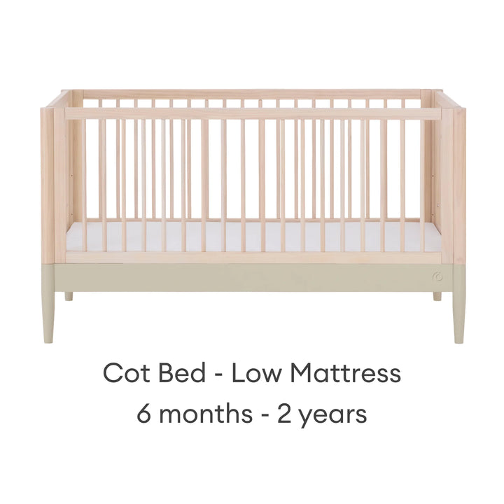 Gaia Baby Eos convertible cot in natural desert sage finish with mattress in low position for 6 months to 2 years on a white background