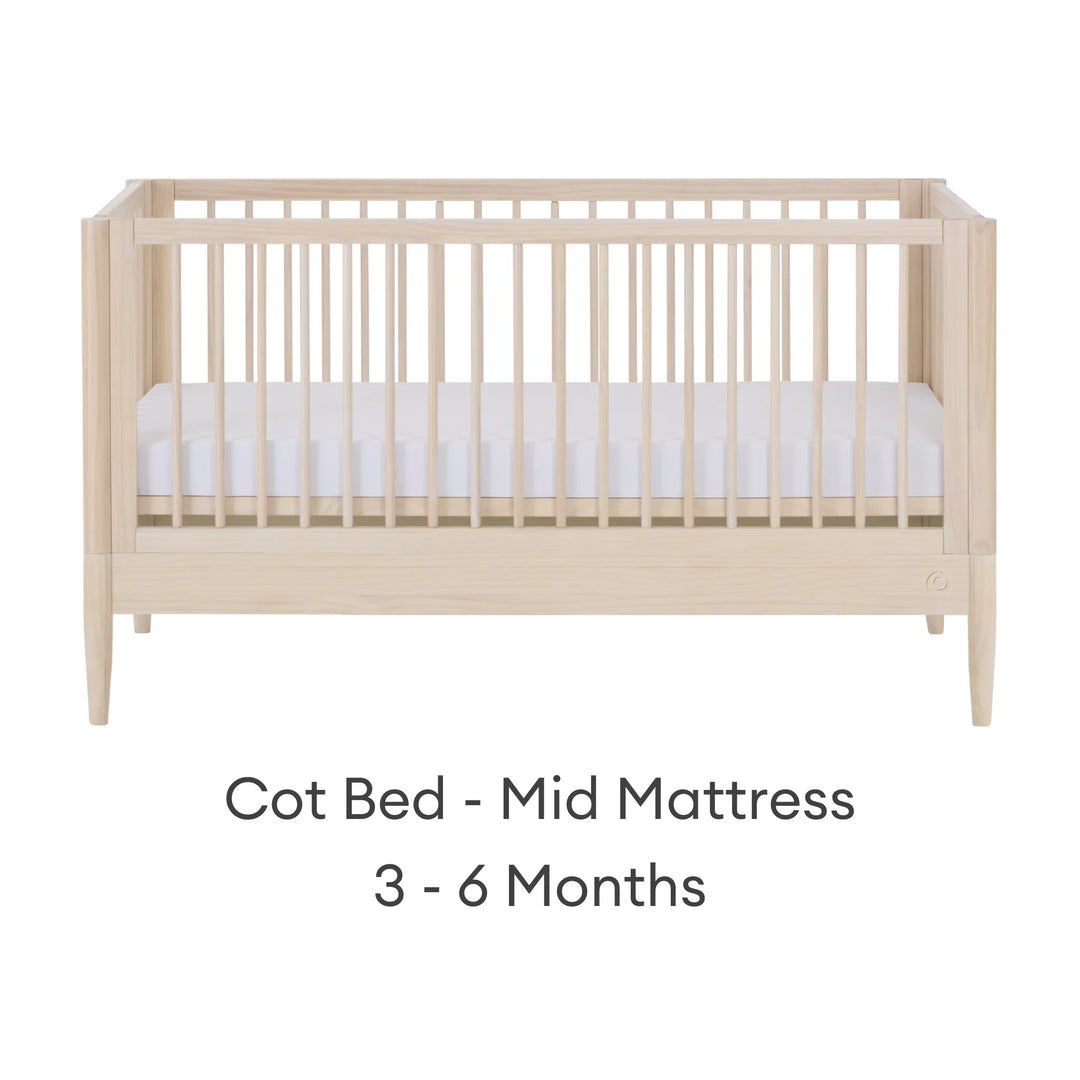 Gaia Baby Eos convertible cot in all-natural wood finish with mattress in mid position for 3–6 months on a white background.