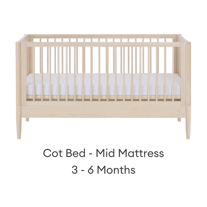 Gaia Baby Eos convertible cot in all-natural wood finish with mattress in mid position for 3–6 months on a white background.