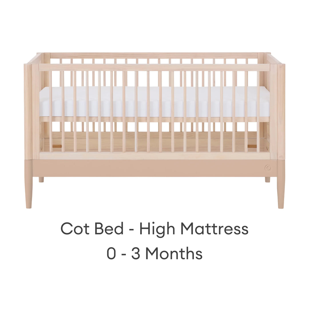 Gaia Baby Eos convertible cot in natural wood and powder blush finish with mattress in high newborn position for 0–3 months on a white background.