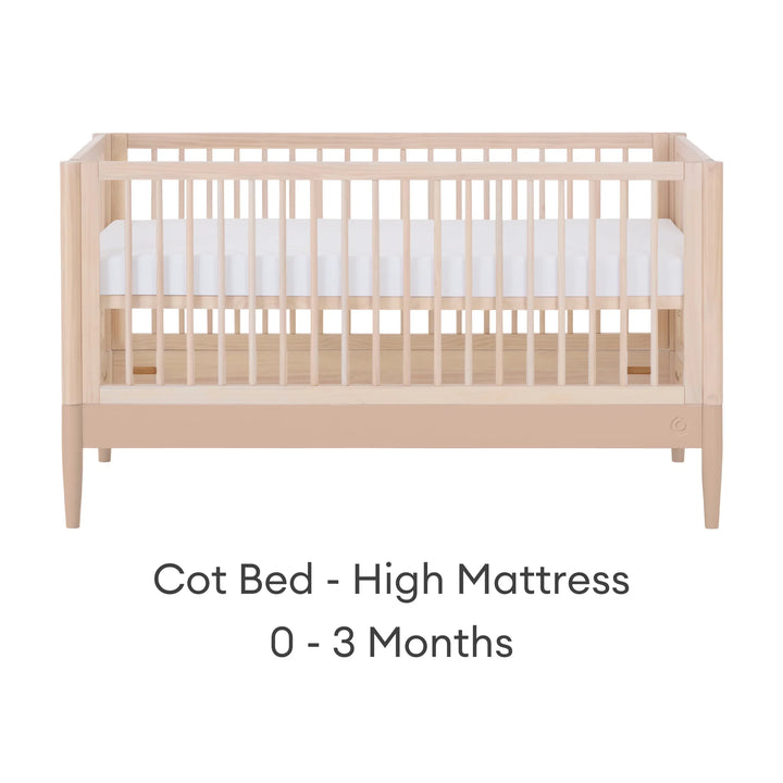 Gaia Baby Eos convertible cot in natural wood and powder blush finish with mattress in high newborn position for 0–3 months on a white background.