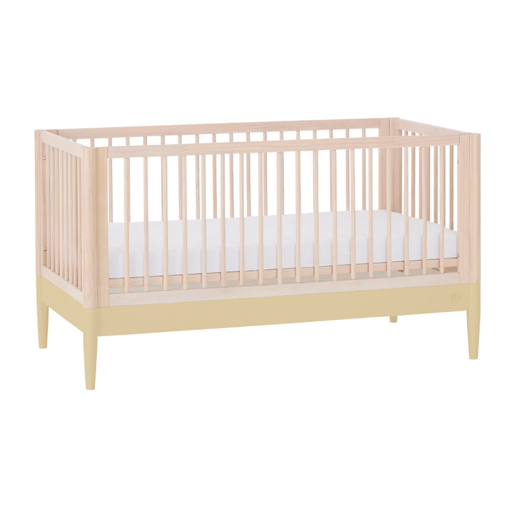 Gaia Baby Eos convertible cot bed in natural wood and yellow with white mattress, modern nursery crib