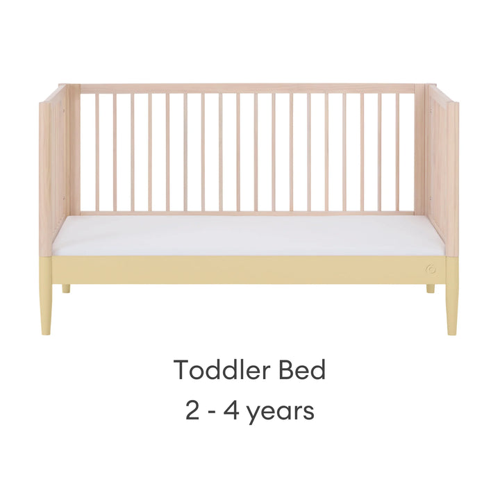 Gaia Baby Eos convertible cot bed in natural wood and yellow converted to toddler bed with white mattress (2–4 years)