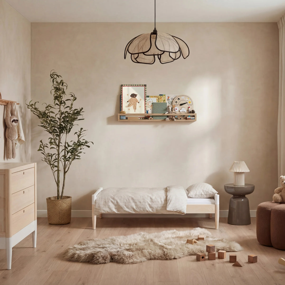 Gaia Baby EOS convertible cot in natural wood and white shown as toddler bed in a modern nursery with soft decor and wooden toys