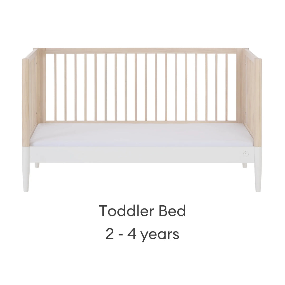 Gaia Baby Eos convertible cot in natural wood and white finish configured as a toddler bed for 2–4 years on a white background.