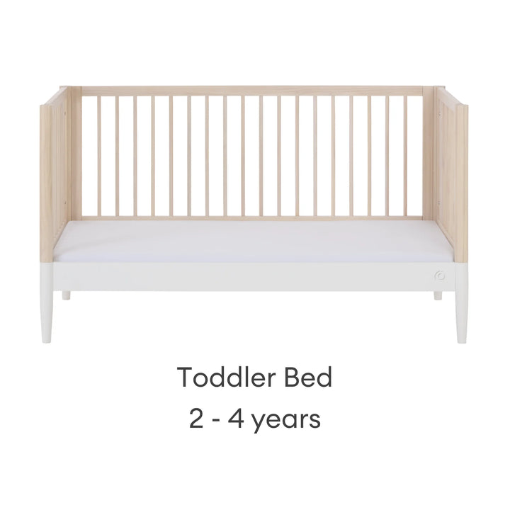 Gaia Baby Eos convertible cot in natural wood and white finish configured as a toddler bed for 2–4 years on a white background.