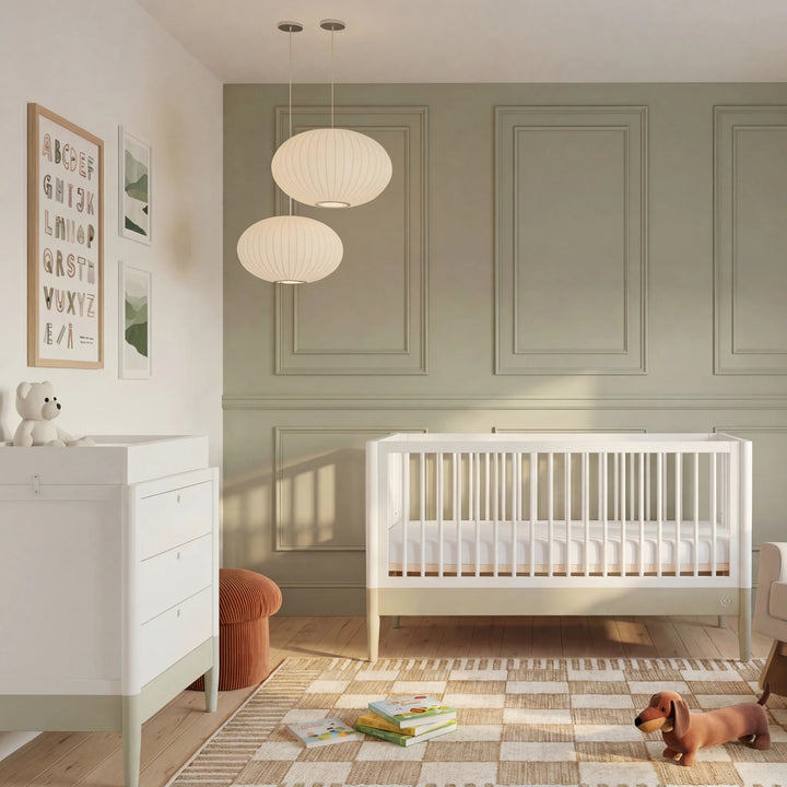 Gaia Baby Eos convertible cot bed white and cashmere in modern nursery with dresser storage unit and wooden floor baby crib setup