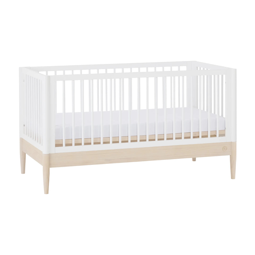 Gaia Baby Eos convertible cot bed white and natural wood angled view modern wooden baby crib with slatted sides and elevated legs