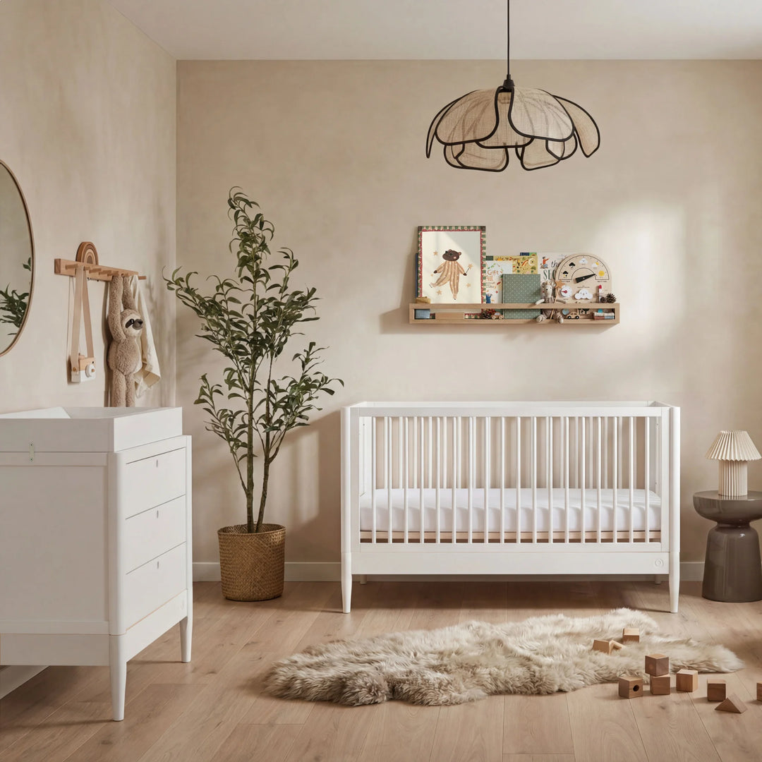 Gaia Baby Eos cot bed and dresser set in all white styled in modern nursery room with baby crib and storage furniture