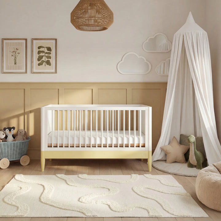 Gaia Baby Eos cot bed in white and yellow styled in modern nursery room with baby crib and soft neutral decor