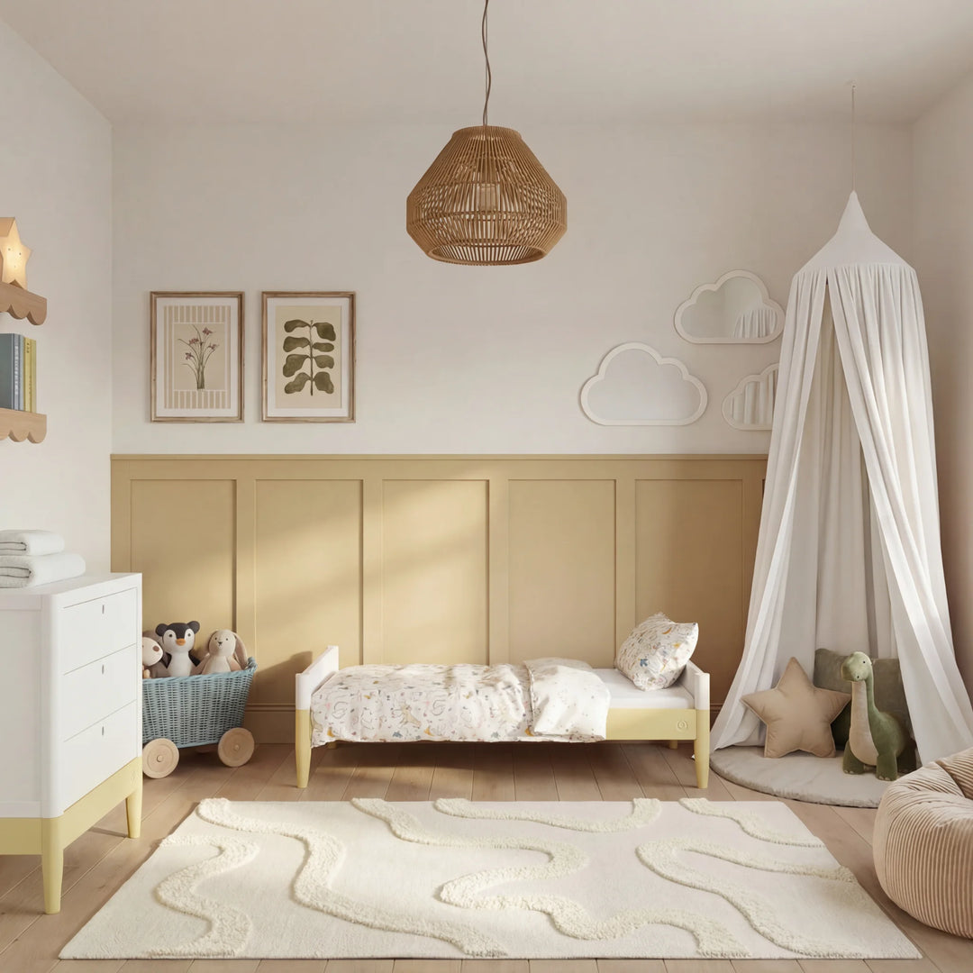 Gaia Baby Eos cot bed in white and yellow converted to toddler bed styled in modern nursery room with soft decor