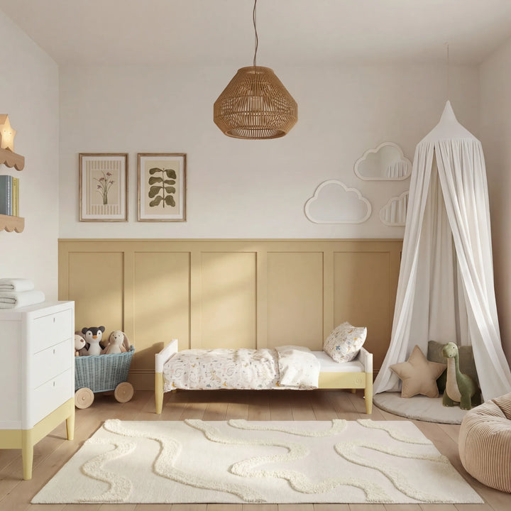 Gaia Baby Eos cot bed in white and yellow converted to toddler bed styled in modern nursery room with soft decor