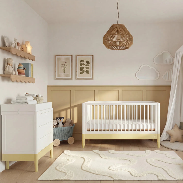 Gaia Baby Eos cot bed and dresser set in white and yellow styled in modern nursery room with baby crib and storage furniture