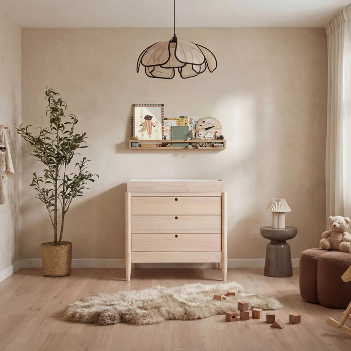 Gaia Baby Eos dresser in all natural wood with changing top in a warm neutral nursery with soft decor