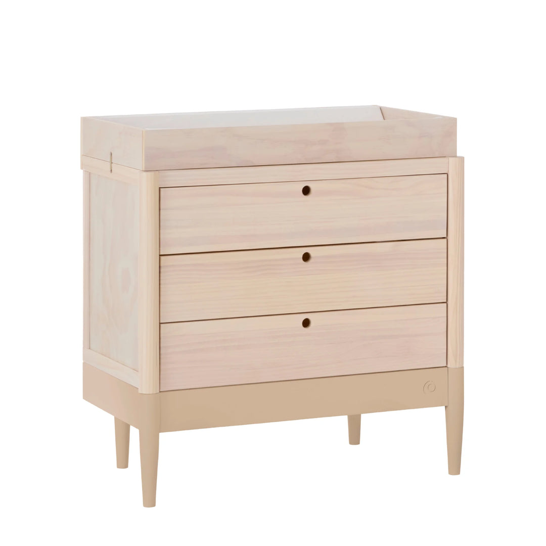 Gaia Baby Eos dresser in natural wood and powder blush angled on a white background