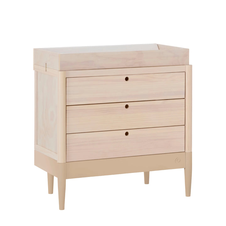 Gaia Baby Eos dresser in natural wood and powder blush angled on a white background