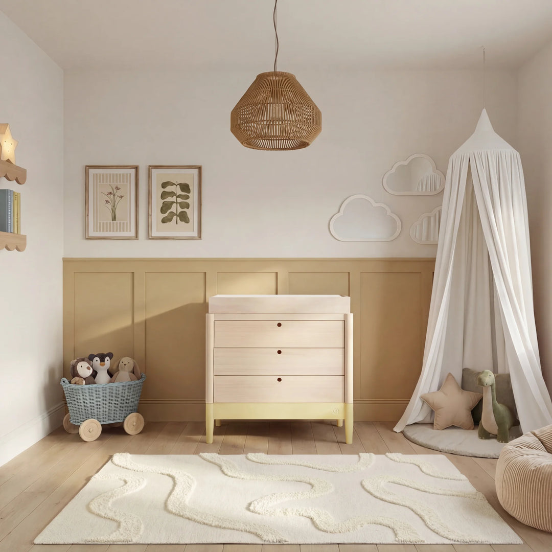 Gaia Baby Eos dresser with changer in natural wood and primrose yellow in a styled nursery room