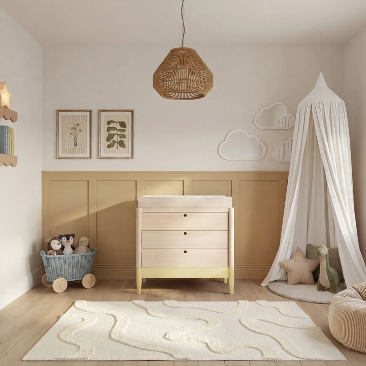 Gaia Baby Eos dresser with changer in natural wood and primrose yellow in a styled nursery room
