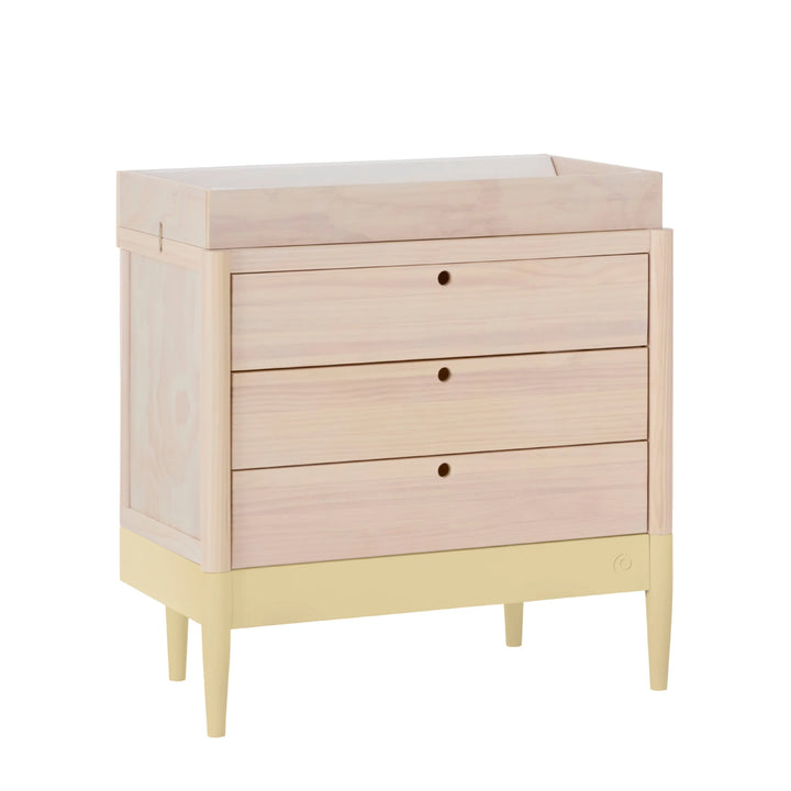 Gaia Baby Eos dresser with changer in natural wood and primrose yellow angled view on white background
