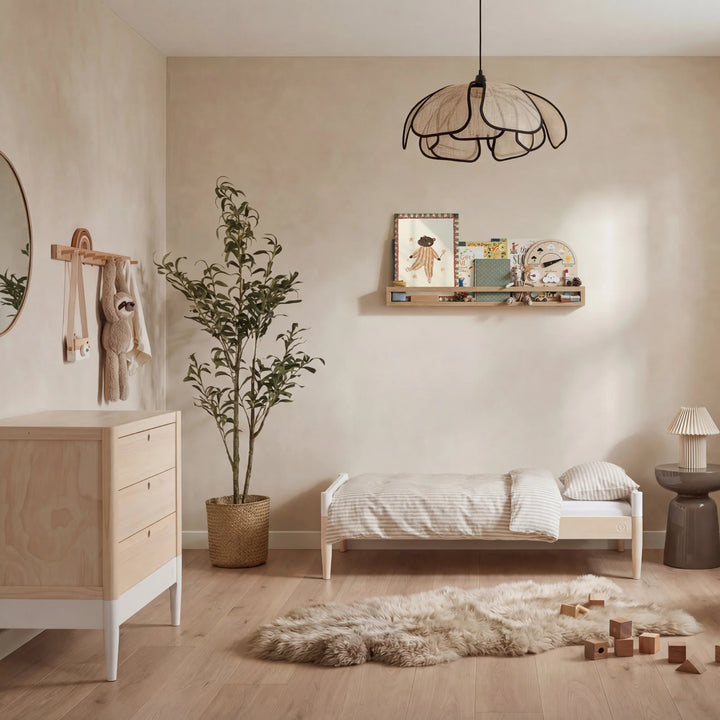 Gaia Baby Eos dresser in natural wood and white in a modern nursery with toddler bed and soft neutral decor