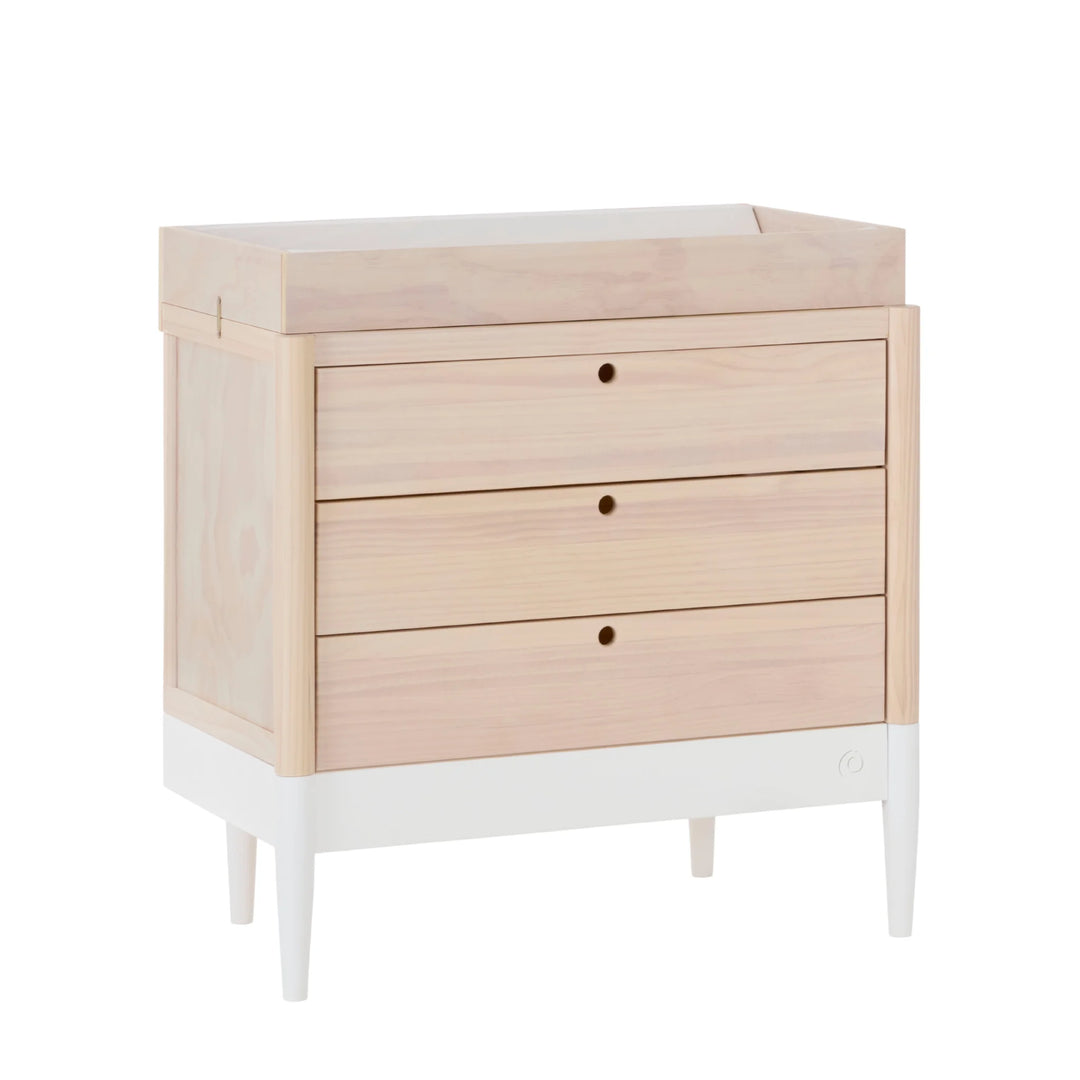 Gaia Baby Eos dresser with changing top in natural wood and white, angled view with three drawers for nursery storage