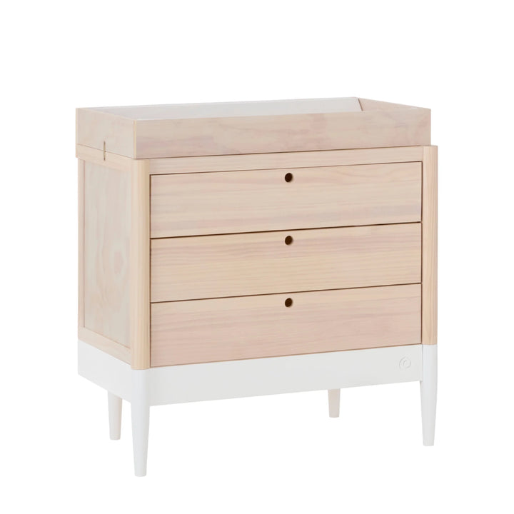 Gaia Baby Eos dresser with changing top in natural wood and white, angled view with three drawers for nursery storage