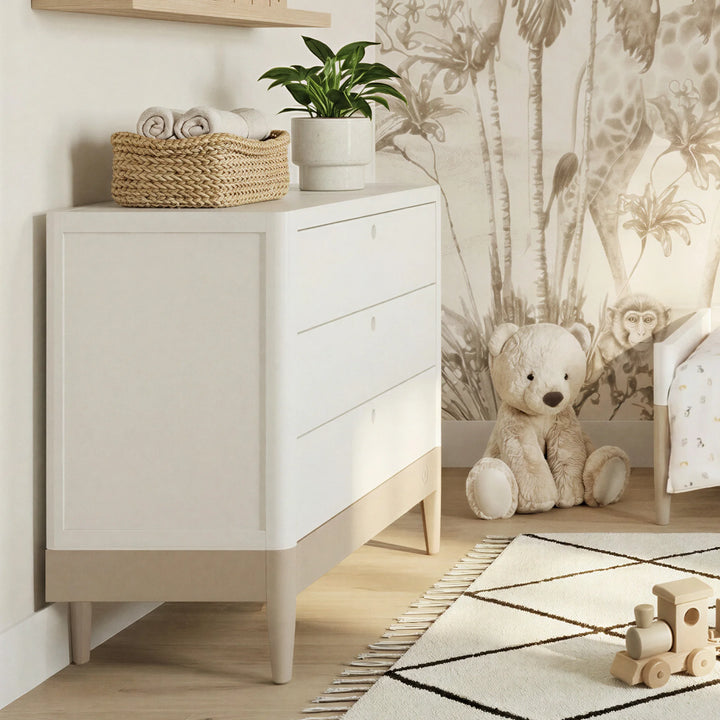 Gaia Baby Eos dresser with changer in white and cashmere in nursery with animal wallpaper and teddy bear