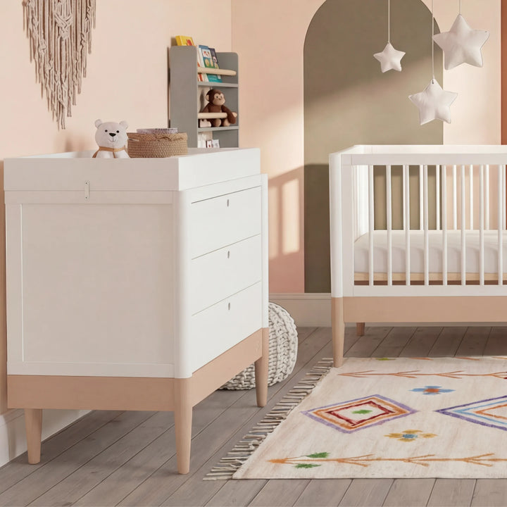 Gaia Baby Eos white dresser and cot bed set with natural wood base in a modern nursery