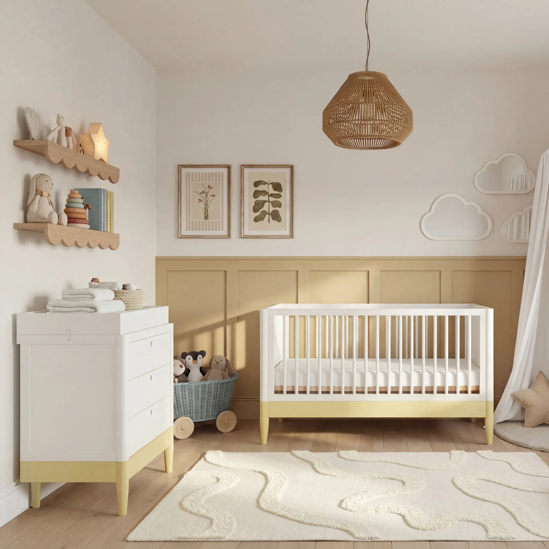 Gaia Baby Eos dresser in white and primrose yellow in a modern nursery with cot, canopy, rug and soft toys