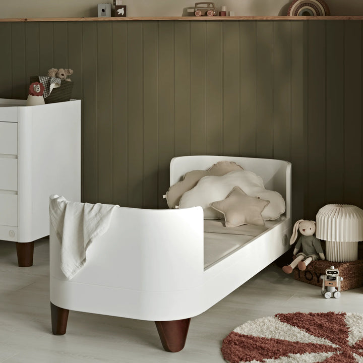 Serena cot bed in first bed mode in a green themed toddlers room.