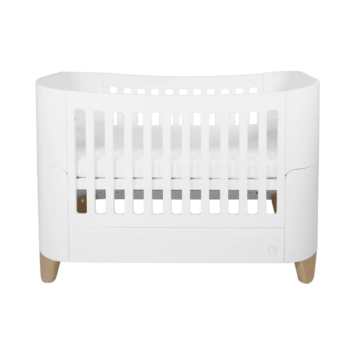Serena real wood convertible cot bed with natural legs on a white background.