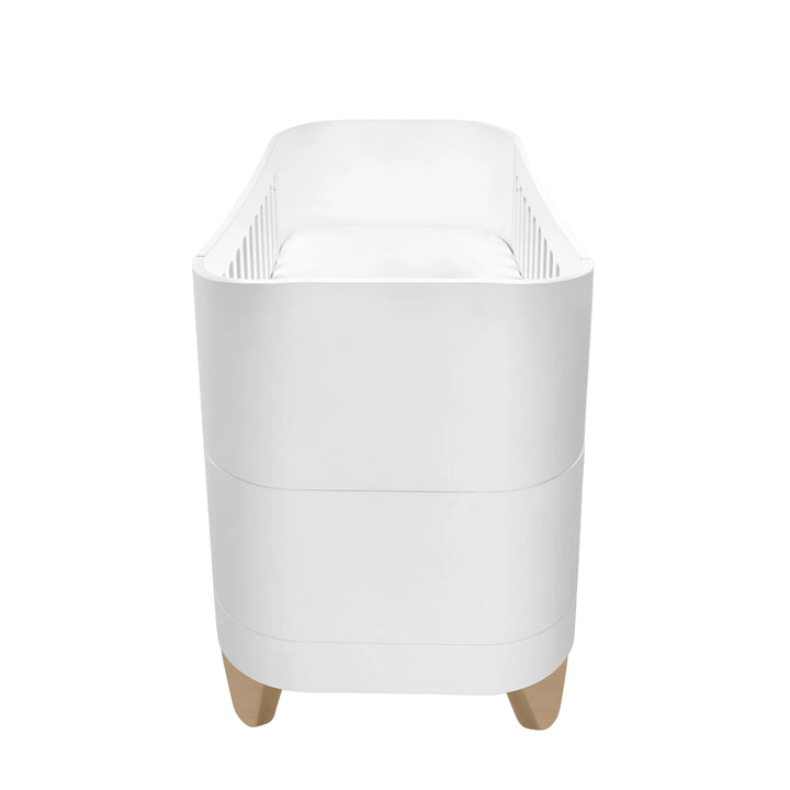 Side view of Serena Cot Bed with natural legs.